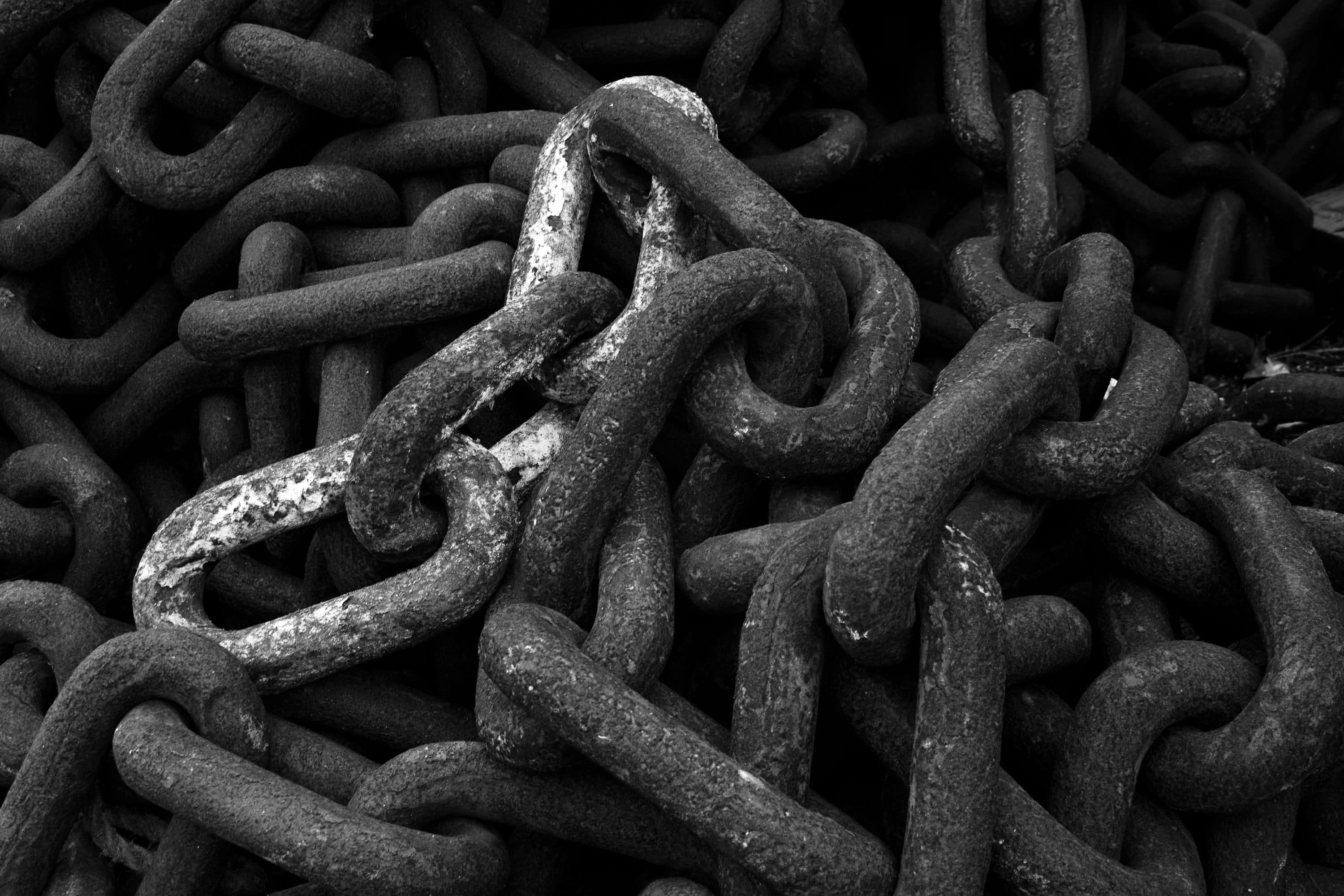 Grayscale metal chain, representing linked workflow stages